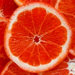 Grapefruit slice atop a pile of other slices